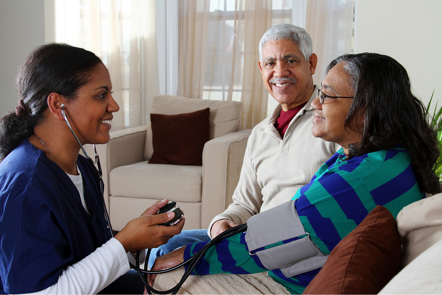 healthcare staff getting blood pressure to an old woman