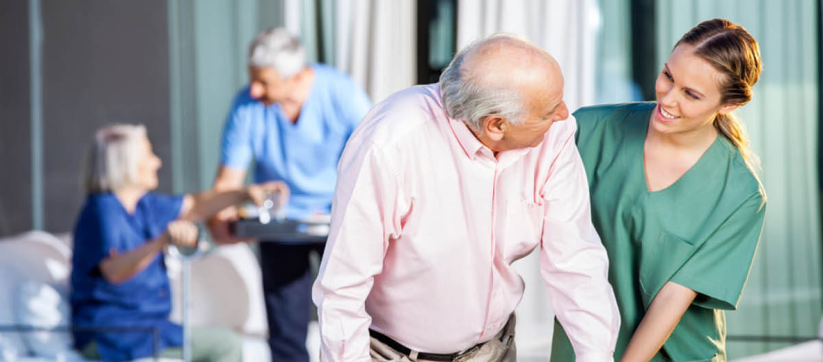 staff-and-an-elderly-looking-at-each-other